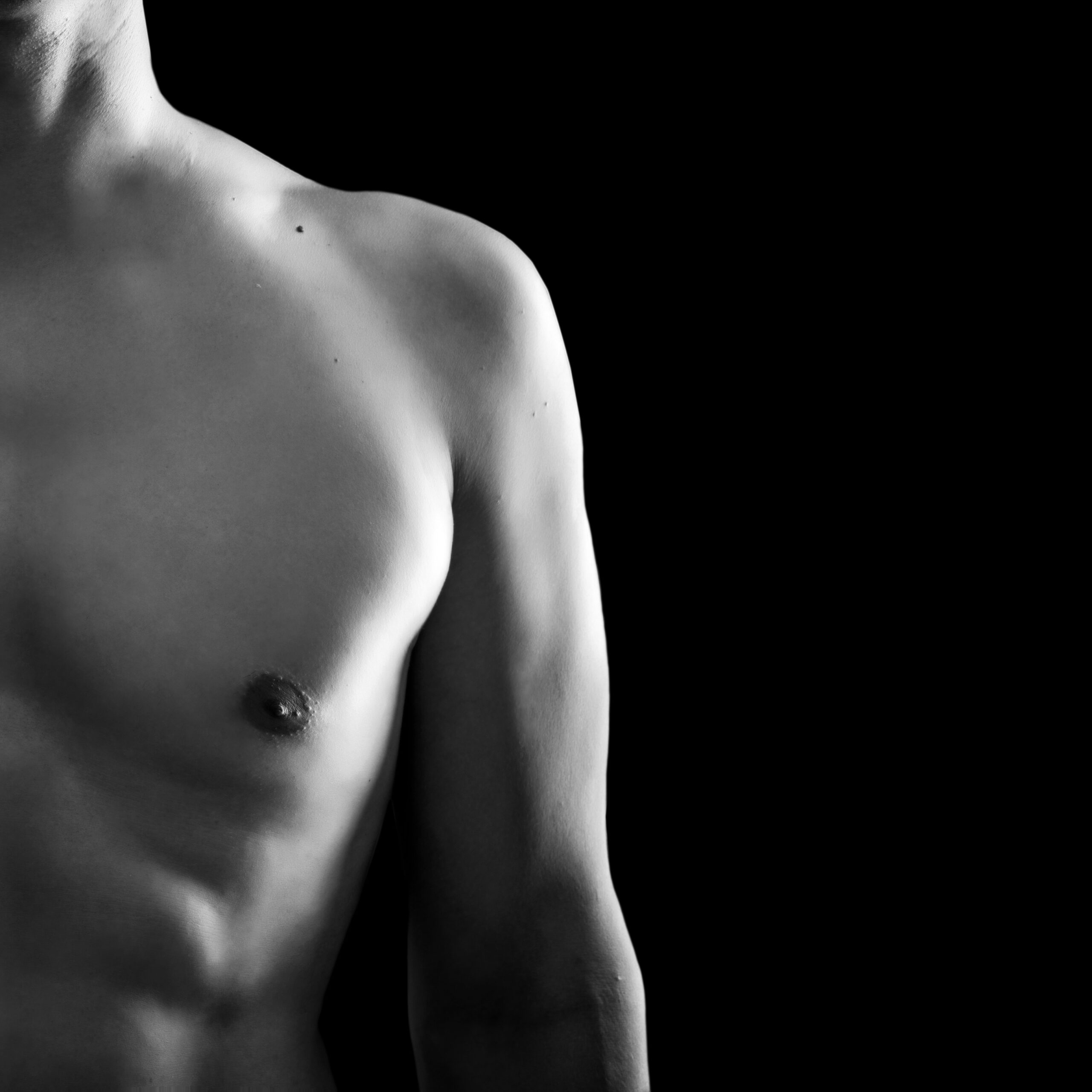 Perfect young adult male torso on black background